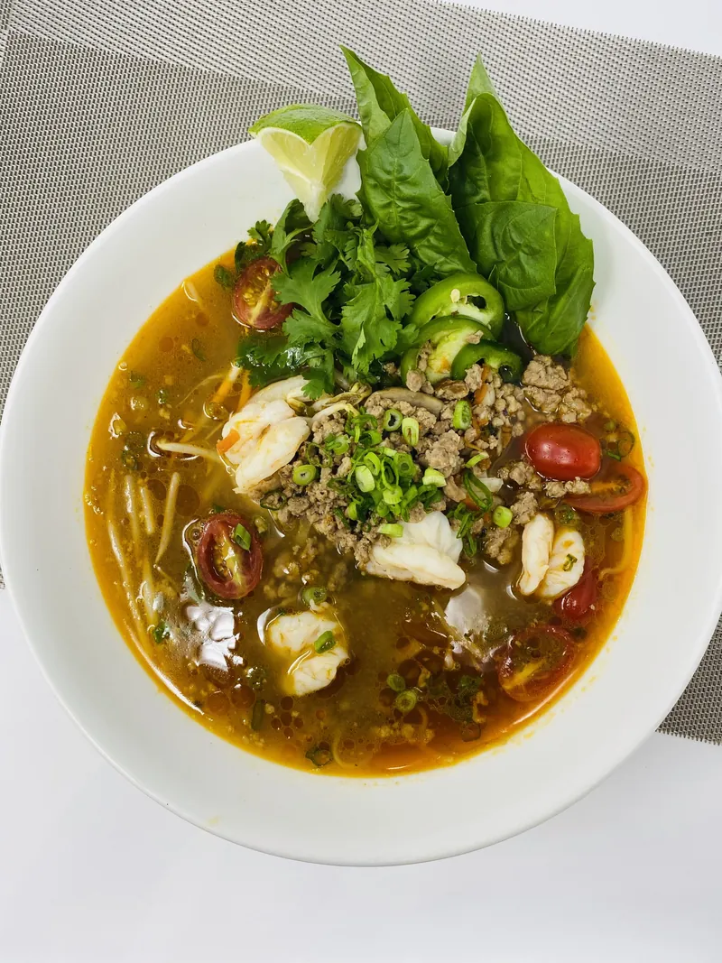 Vietnamese beef pho with fresh herbs