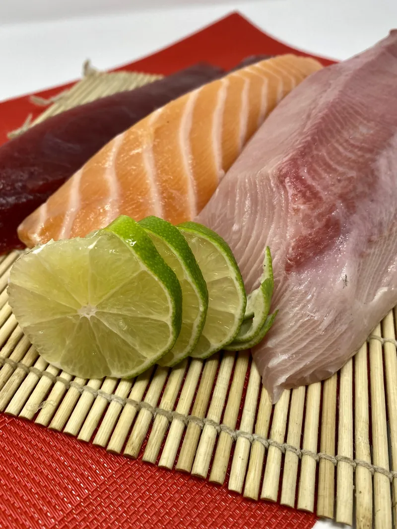 Salmon and yellowtail sashimi with lime slices