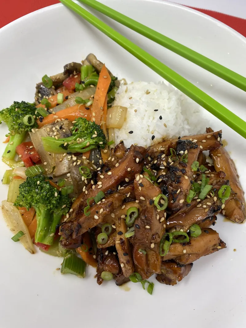 Sauteed sesame beef rice bowl with vegetables