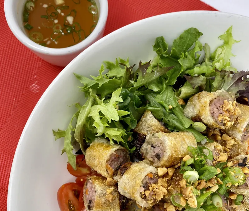 Vermicelli bowl with egg rolls and ginger vinaigrette